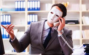 Businessman with mask in office hypocrisy concept
